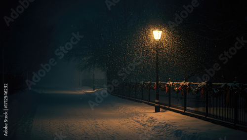 a street lamp on a snowy street at night