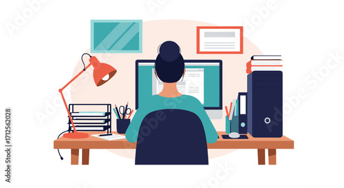 A woman works at a computer in her home office.