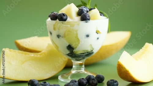 summer fruit dessert with yogurt on green background