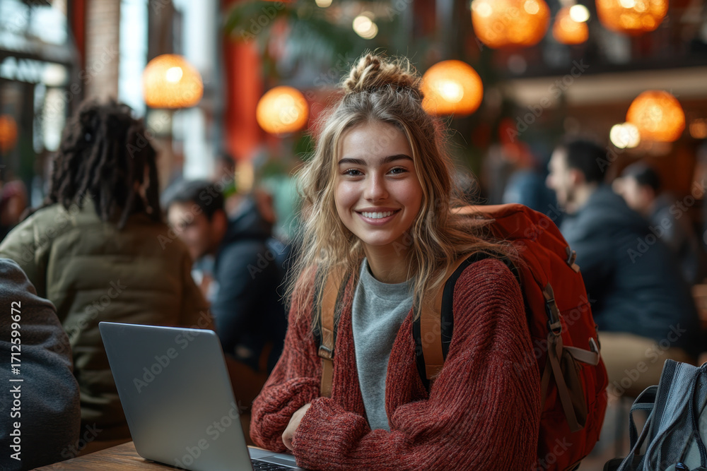 Obraz premium Woman sitting at table with laptop.