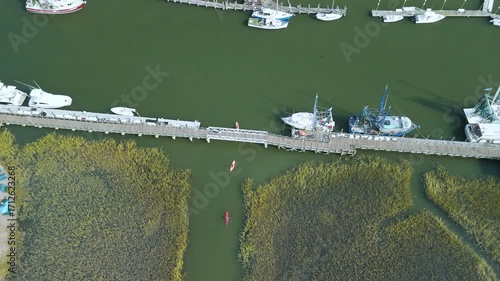 Aerial shot of 3 kayakers , kayaking in lowland marsh in charleston sc