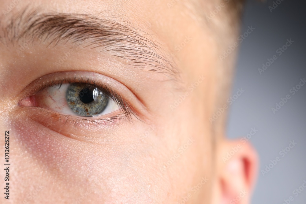 Fototapeta premium Man with beautiful eyes on light grey background, closeup