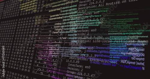 Color-coded code, network config and hex dumps appearing on monitor at desk, with terminal window