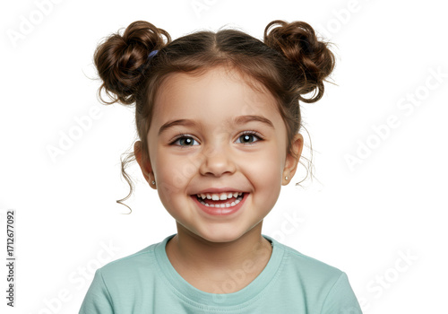 Isolated girl smiles wearing space buns hairstyle, cheerful kid, face closeup, looking at camera