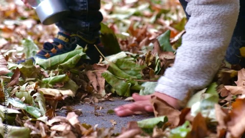 Autumn city. A child plays with autumn leaves. Autumn leaves. 