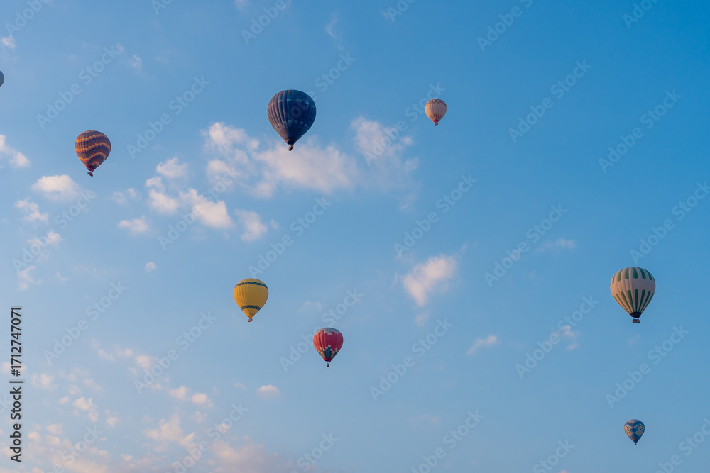Obraz premium Three hot air balloons against a blue sky. Beautiful view of colourful hot air balloons from below. Cappadocia