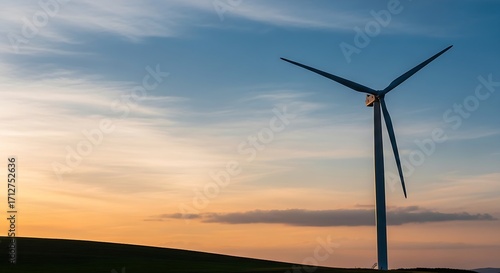 Renewable energy concept of a wind turbine generating power against a vibrant sunset sky, symbolizing clean electricity and sustainable future growth