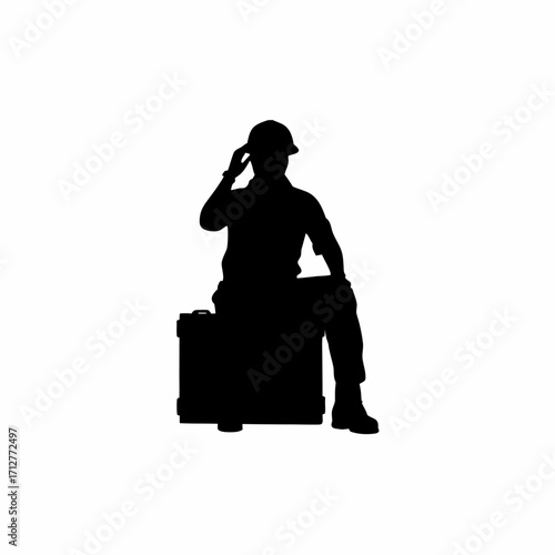 Silhouette of construction worker taking a break on a toolbox inside a tunnel isolated on white background