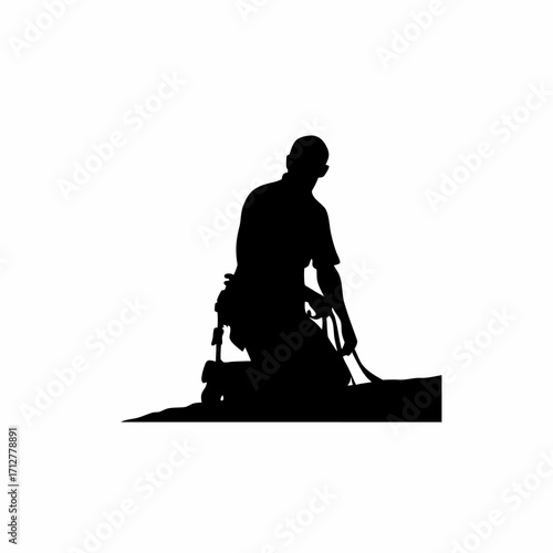 Silhouette of roofing worker kneeling on rooftop with safety harness isolated on white background
