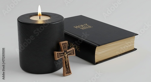 A lit candle, a bible, and a rosary isolated on white background