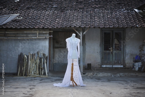 Elegant Wedding Dress on a Mannequin Outdoors in a Rustic Setting