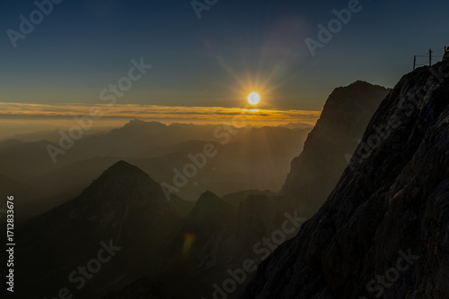 Alps mountains scenic landscape in summer. Austrian Alps scenery trekking path among the high mountain peaks in summer. Green mountain valleys with rocky peaks and lake in the Alps in Austria