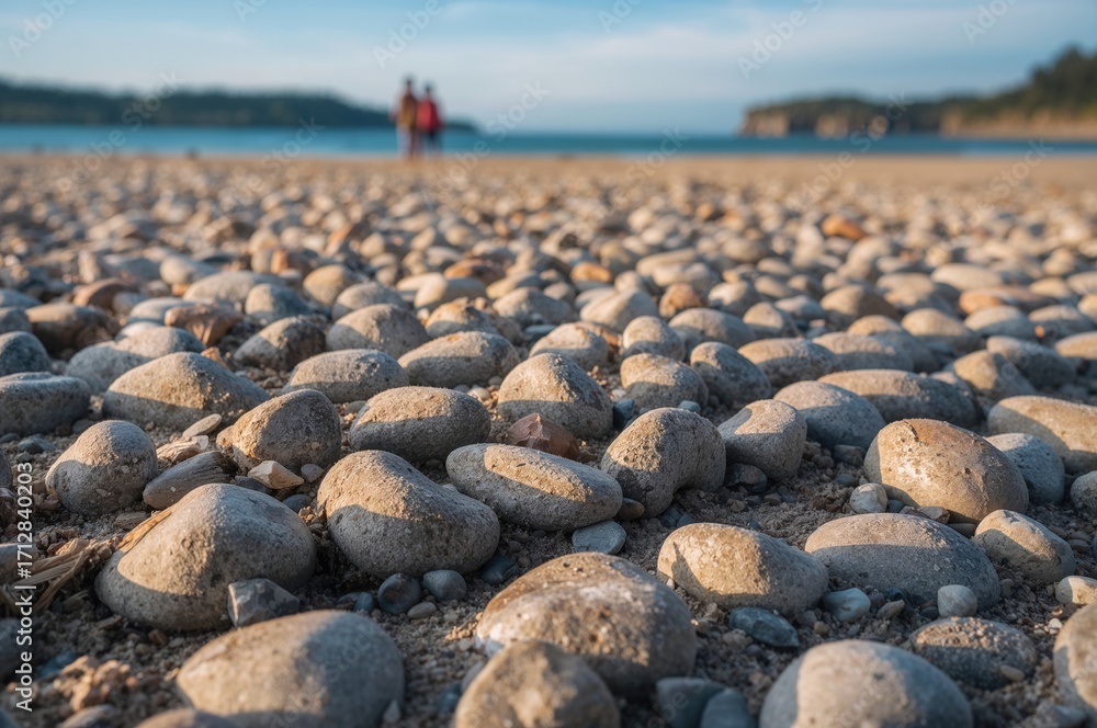 Obraz premium Layered pebbles stacked on a sandy shore