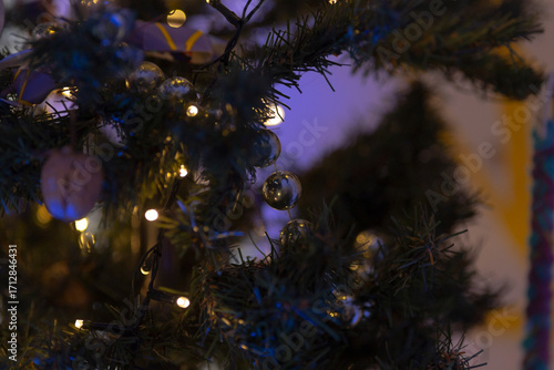 A beautifully decorated Christmas tree with sparkling lights and ornaments, creating a warm holiday atmosphere.