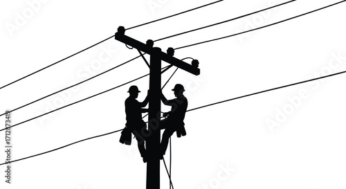 Linemen working on high voltage power lines a striking silhouette