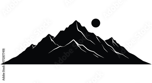 Dramatic mountain range with a full moon a striking black silhouette