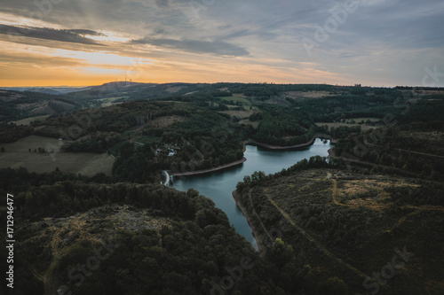 Golden Hour Over Misty Lake and Tree Line