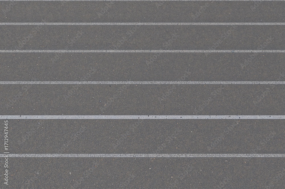 Fototapeta premium Athlete Positioned on Starting Line of Running Track, Preparing for Race Challenge on Grey Asphalt Surface