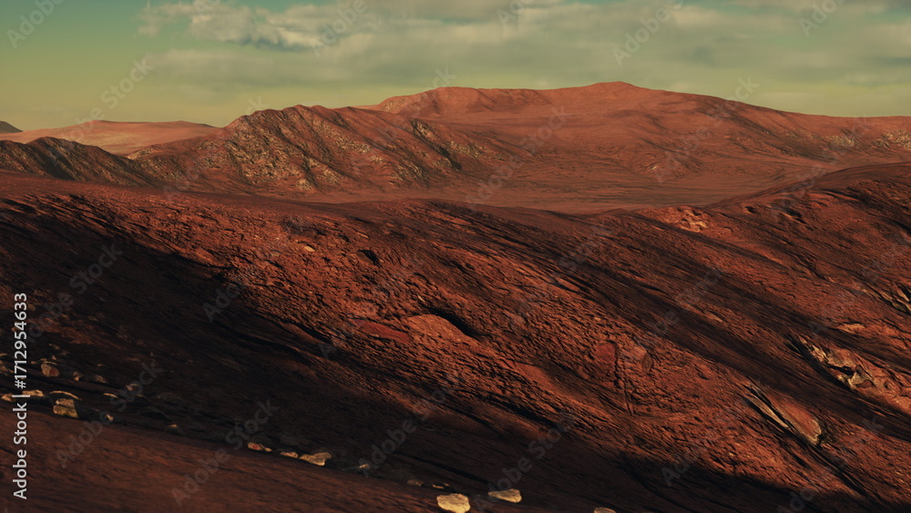 Fototapeta premium A breathtaking red landscape stretches across the horizon with rugged mountains in the distance. The vivid colors showcase the beauty of nature under a bright, clear sky at sunset.