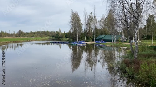 A stunning and serene lakeside view featuring boats surrounded by lush greenery