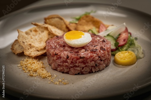 Raw meat tartare garnished ...