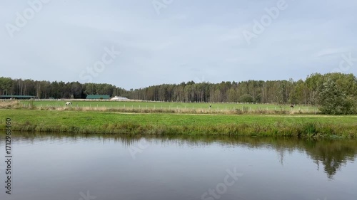 A stunning scenic rural landscape featuring a beautiful reflection in the calm water surface