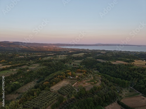Sunset over fields and forest near Lake Bolsena, Italy
Drone image showing rolling hills, farmland and forest leading to Lake Bolsena at sunset, with the full moon visible.