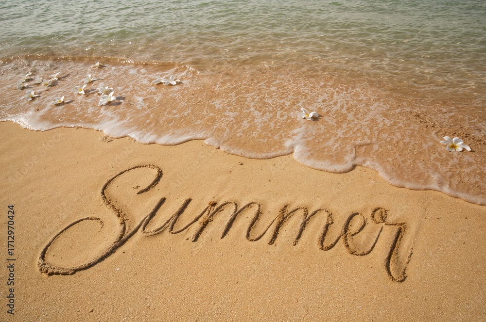 Fototapeta premium Summer spelled out in beach sand accompanied by a plumeria flower