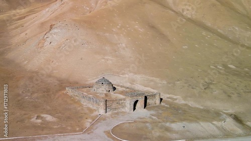 Aerial drone view of the ancient Tash Rabat caravanserai, built in the 15th century. Located in the mountains of the Tien Shan at an altitude of over 3500 m above sea level.