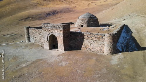 Aerial drone view of the ancient Tash Rabat caravanserai, built in the 15th century. Located in the mountains of the Tien Shan at an altitude of over 3500 m above sea level.