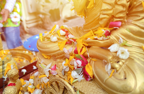 Close up Buddha statue with raw of Brass. Hand of buddha statue with leaf on the lap of buddha. Believe, Culture, Traditional. Buddhist believe concept. Calm concept. meditation concept.