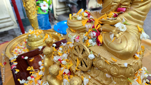 Close up Buddha statue with raw of Brass. Hand of buddha statue with leaf on the lap of buddha. Believe, Culture, Traditional. Buddhist believe concept. Calm concept. meditation concept.