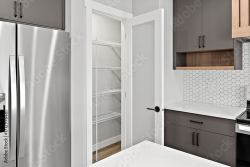 Kitchen with a white tile backsplash and a silver refrigerator