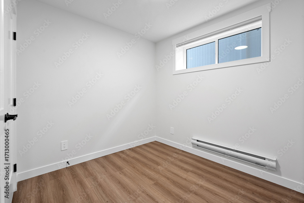 Fototapeta premium Small, empty room with a window and a radiator