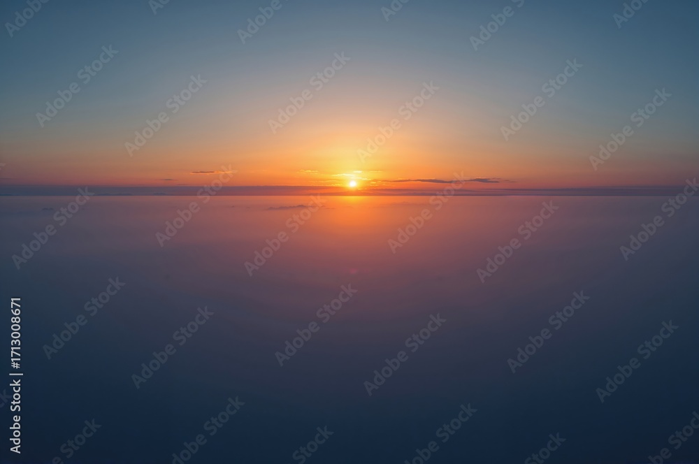 Obraz premium A captivating shot showcasing the peaceful beauty of dawn, illuminating a vast landscape with soft, warm hues. The skyline is adorned with a mix of amber and azure shades.