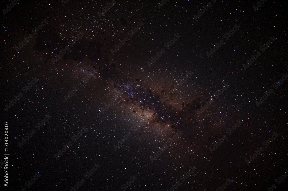 Fototapeta premium Colorful cosmic view featuring a field of stars and a nebula far beyond any planetary system.