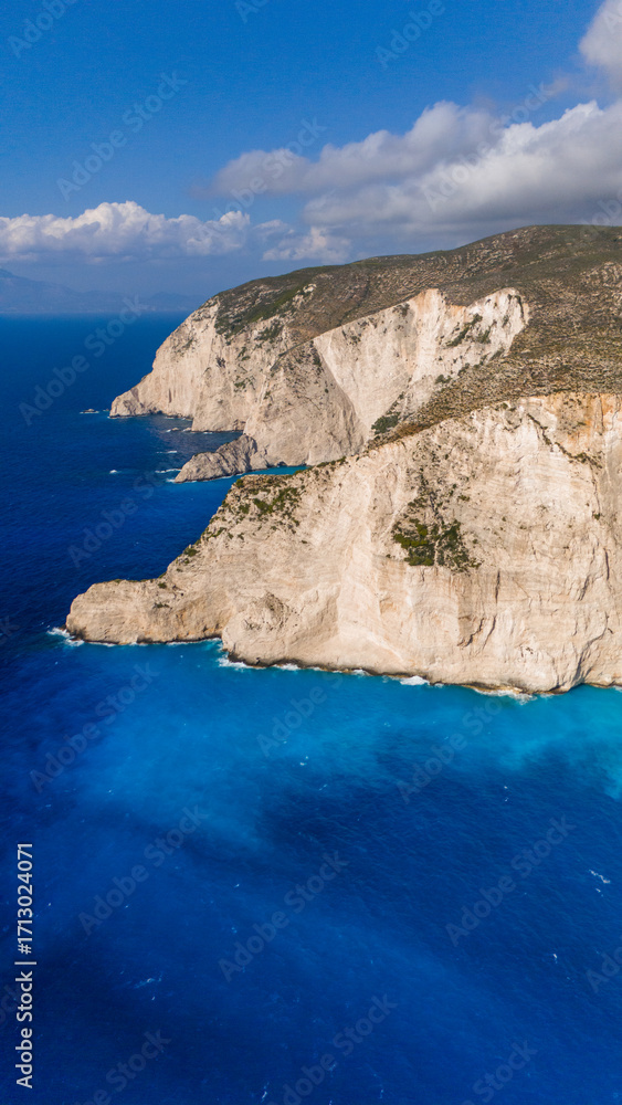 Fototapeta premium Brilliant turquoise Ionian Sea along Zakynthos Greece white cliffs with dramatic coastal scenery and vibrant colors seen from above