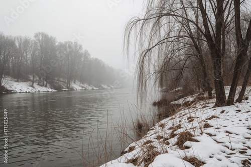 Riverbank with leafless trees in the onset of winter. Landscape of a Siberian valley.