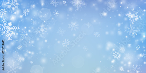 Blue winter sky background. Soft white snowflakes falling on a light blue gradient backdrop, glowing bokeh lights. Peaceful snowy landscape, wallpaper for holiday designs, banners, greeting cards.