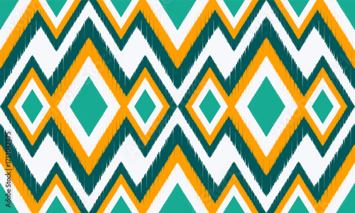 Seamless ethnic Ikat geometric. Green and Orange ikat fabric pattern