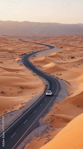 Aerial above long desert highway disappearing into horizon