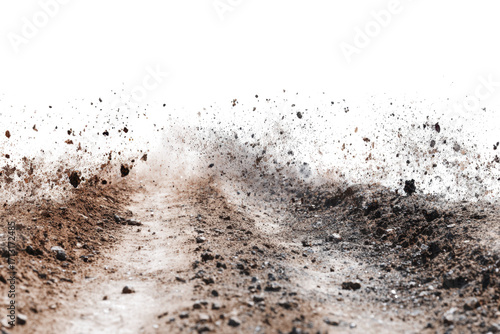 A dirt road with dust and debris kicked up, suggesting movement or an explosion.