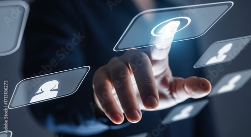 A business professional's hand selecting a digital user profile icon on a futuristic touchscreen interface.