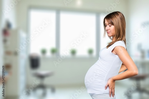 Pregnant young woman holds belly with her baby Free Download Pregnant young woman holds belly with her baby - GFXLoad
