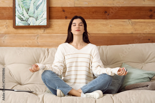 Young woman meditating on c...
