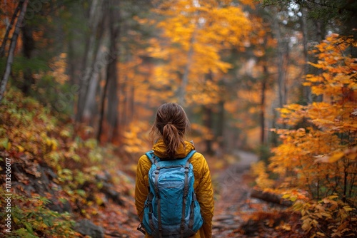 Woman walking in autumn foliage forest woods in city park with backpack. Travel hike fall destination in Quebec, Canada. High quality