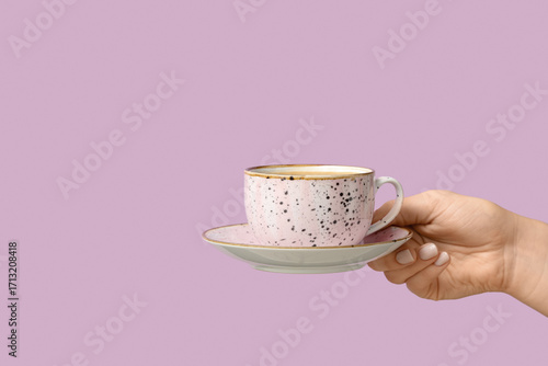 Female hand holding cup of ...