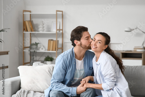 Happy husband kissing his w...