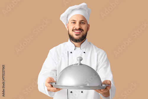Male chef with cloche on be...