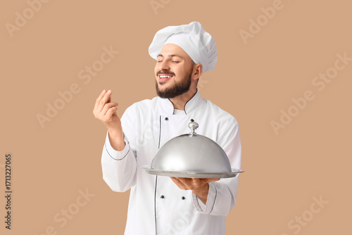 Male chef with cloche on be...